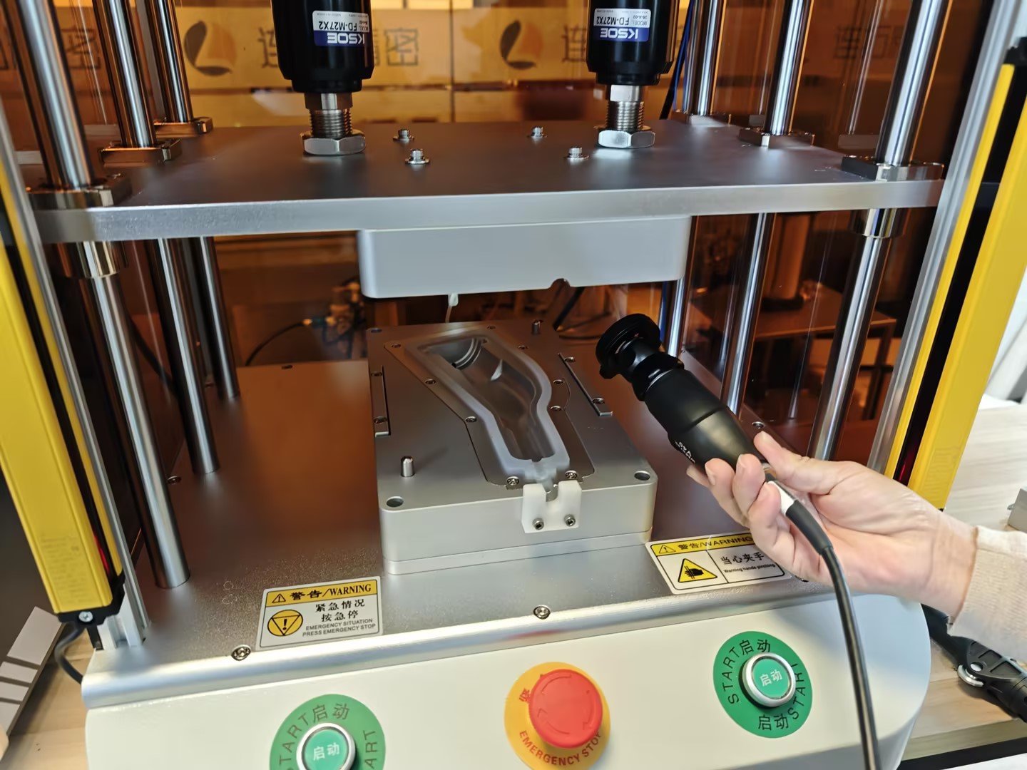 Operator loading camera module into test fixture | Figurtech